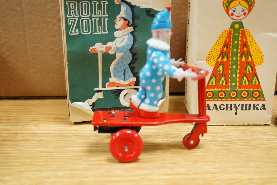 Three boxed clockwork tinplate toys - a 1960s Japanese Cubby the Reading Bear, by Alps (Japan), 17cm high, a USSR doll, and a later ‘Roli Zoli’ clown on a scooter (3)
